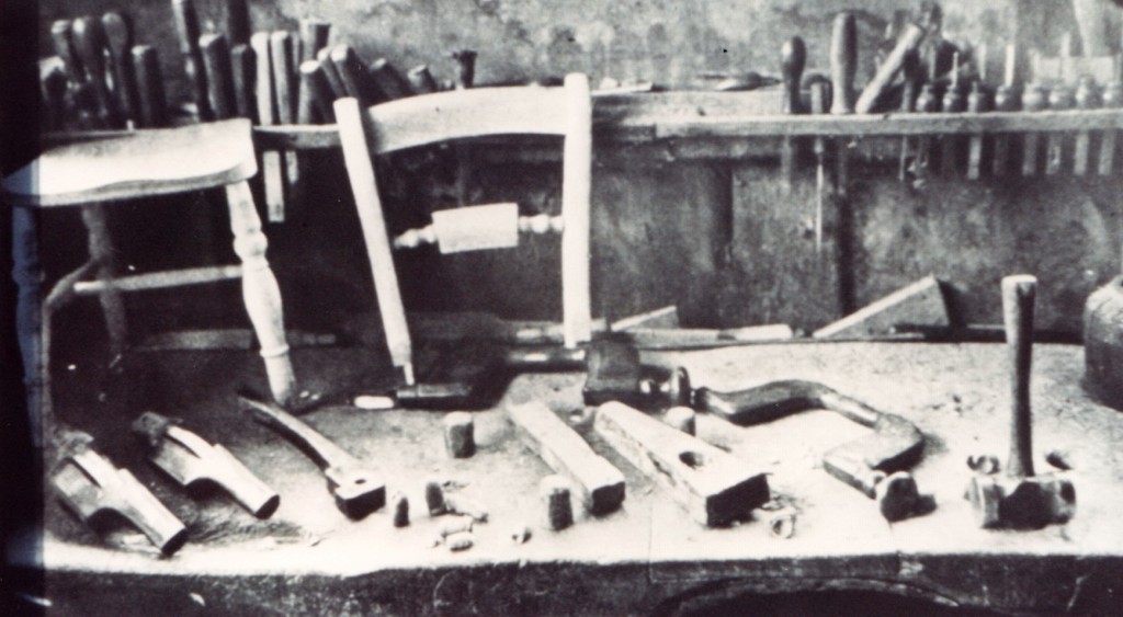 Workmans bench in chair factory with tools and parts of a chair