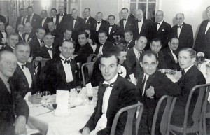 Photograph of formal dinner showing Jack, centre back, standing; Dick Holland, centre forground, next to Jimmy Pigg