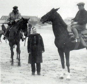Bay Powell and Jack Dowdeswell on horses with Betty Dowdeswell, all on a beach