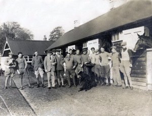 Photograph of Bay Powell with stables staff and jockeys at Hightown, Aldbourne